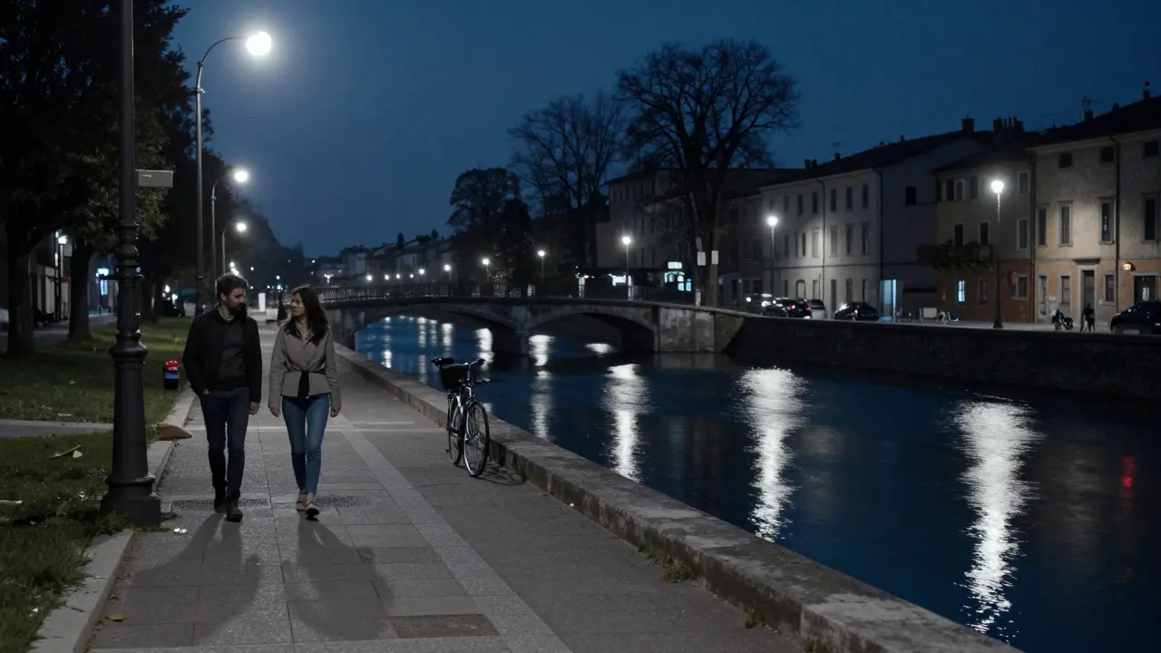 Quiet walk along Naviglio Grande canal at night, reflections glowing on still water.