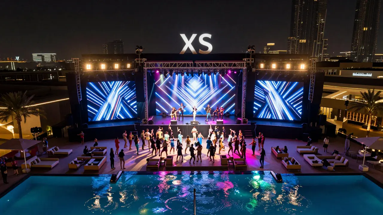 XS Dubai nightclub with massive LED stage and crowd dancing poolside under neon lights.