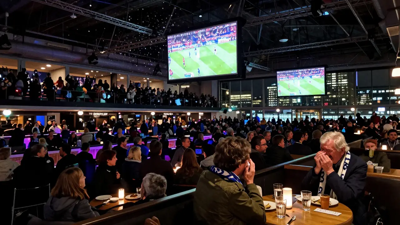 Crowd celebrating at The Sports Bar at The O2 during a Champions League match, multiple screens glowing.